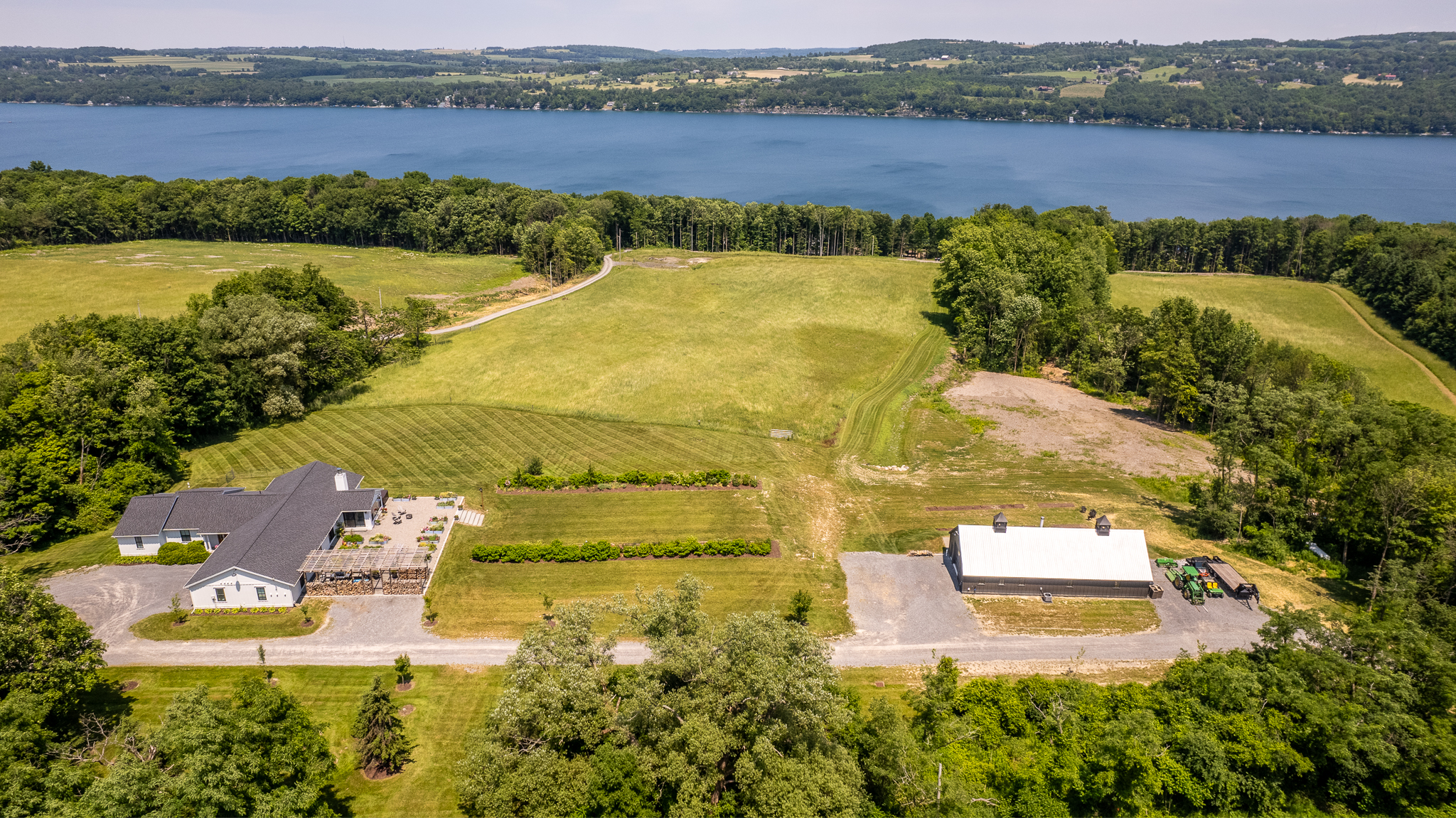 Aerial view of West Lake Farm, its open fields, and Skaneateles Lake